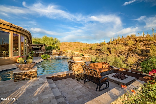 view of patio / terrace with a fenced in pool and a fire pit