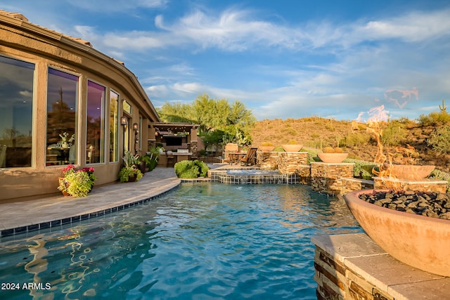 view of pool featuring a patio and a water view