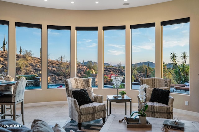 sunroom featuring a mountain view and a healthy amount of sunlight