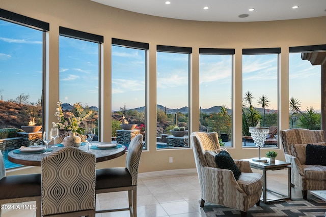 sunroom with a mountain view and a wealth of natural light