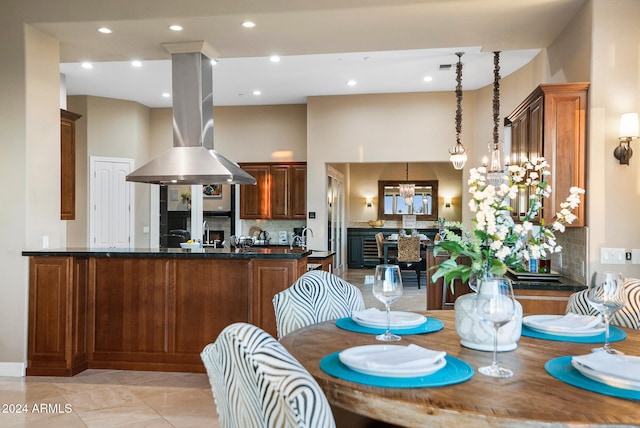 dining space featuring a high ceiling and an inviting chandelier