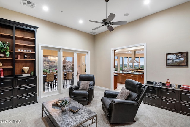 carpeted living room with ceiling fan and a wealth of natural light