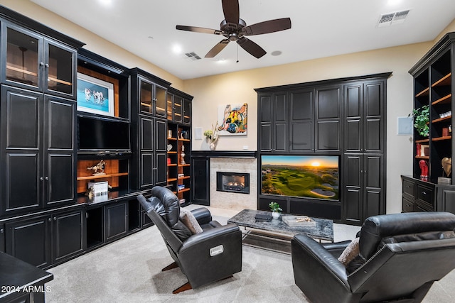 interior space featuring ceiling fan, a fireplace, and light colored carpet