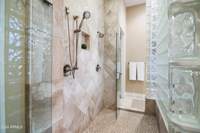 bathroom featuring a shower with door and tile patterned flooring