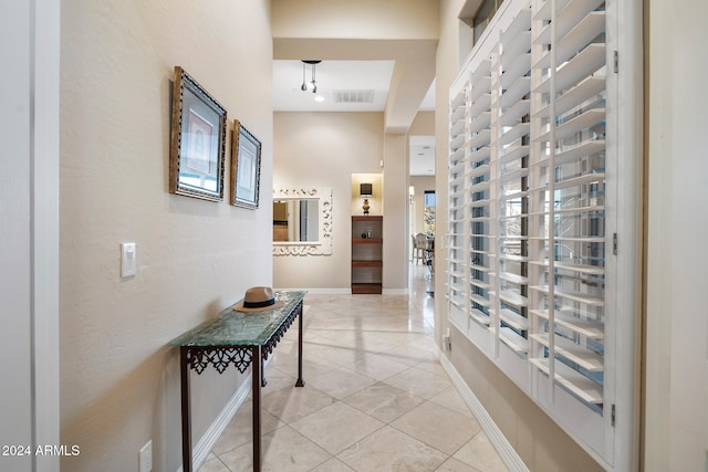 hall with light tile patterned flooring