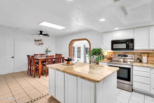 625 S Daley, Mesa, AZ 85204 - kitchen featuring black microwave, stainless steel electric range, light tile patterned floors, recessed lighting, and arched walkways