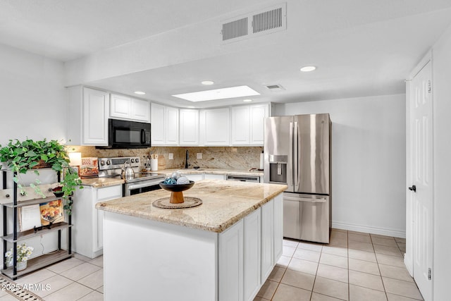 625 S Daley, Mesa, AZ 85204 - kitchen with stainless steel appliances, light tile patterned floors, white cabinetry, tasteful backsplash, and light stone countertops