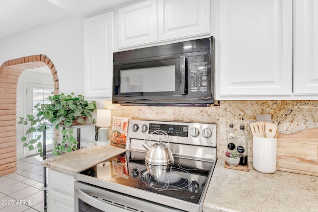 625 S Daley, Mesa, AZ 85204 - kitchen featuring range with electric stovetop, black microwave, backsplash, and white cabinetry