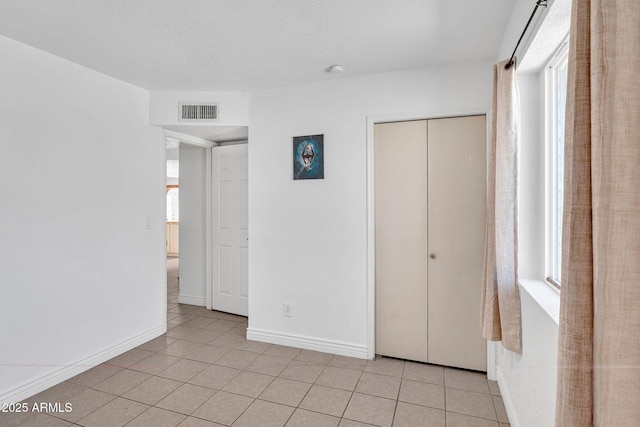 625 S Daley, Mesa, AZ 85204 - unfurnished bedroom with a closet, light tile patterned floors, and baseboards
