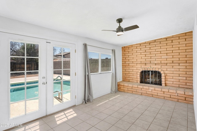 625 S Daley, Mesa, AZ 85204 - unfurnished living room with light tile patterned floors, ceiling fan, a brick fireplace, and plenty of natural light