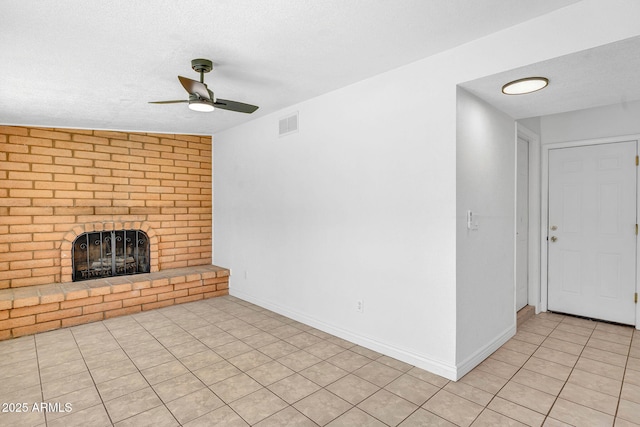 625 S Daley, Mesa, AZ 85204 - unfurnished living room with ceiling fan, a brick fireplace, a textured ceiling, baseboards, and light tile patterned floors
