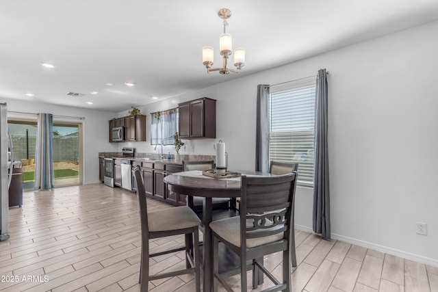 9442 E Silo Rd, Florence, AZ 85132 - dining area with a chandelier, light wood-type flooring, recessed lighting, and baseboards