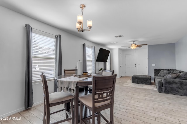 9442 E Silo Rd, Florence, AZ 85132 - dining space featuring light wood-style flooring, ceiling fan, a chandelier, and baseboards