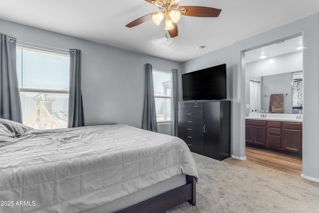 9442 E Silo Rd, Florence, AZ 85132 - bedroom with light carpet, a sink, baseboards, ensuite bath, and a ceiling fan