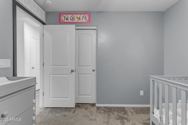 9442 E Silo Rd, Florence, AZ 85132 - unfurnished bedroom with light carpet, baseboards, a closet, and a nursery area