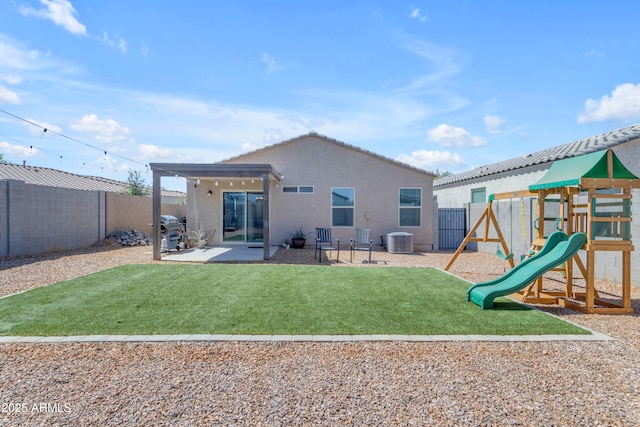 9442 E Silo Rd, Florence, AZ 85132 - back of house featuring central AC unit, stucco siding, a playground, and a patio