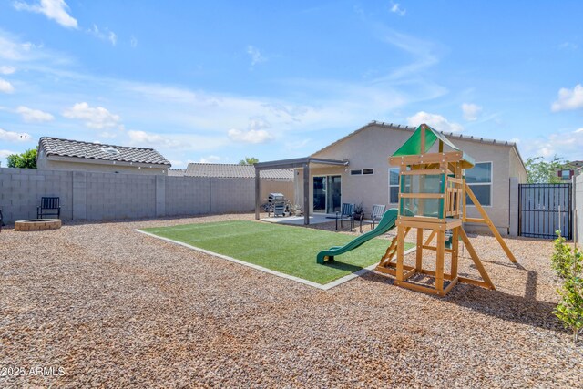 9442 E Silo Rd, Florence, AZ 85132 - back of house with a playground, a fenced backyard, and stucco siding