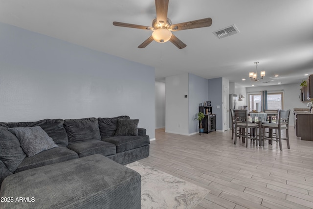 9442 E Silo Rd, Florence, AZ 85132 - living area featuring a chandelier, a ceiling fan, light wood finished floors, and baseboards