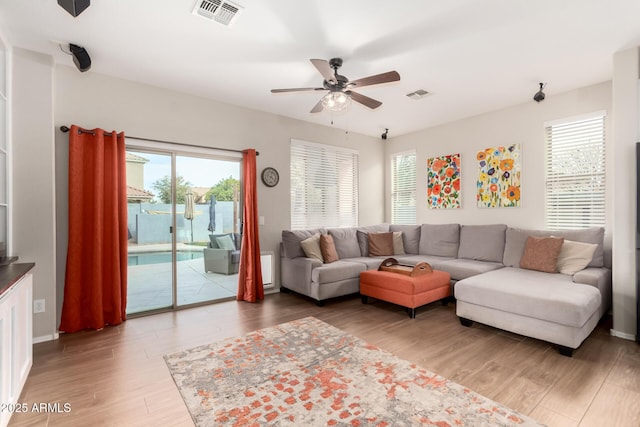 living room featuring ceiling fan, wood finished floors, and visible vents