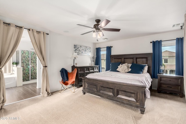 bedroom featuring light colored carpet, visible vents, and ceiling fan