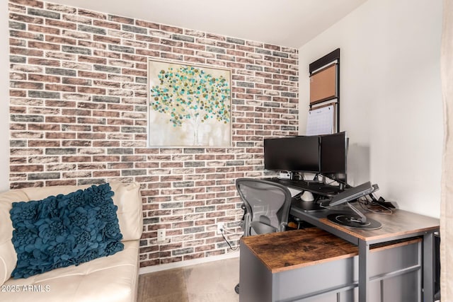 office area with brick wall and wood finished floors