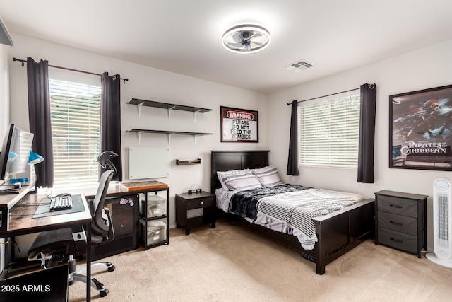 bedroom featuring visible vents and light colored carpet