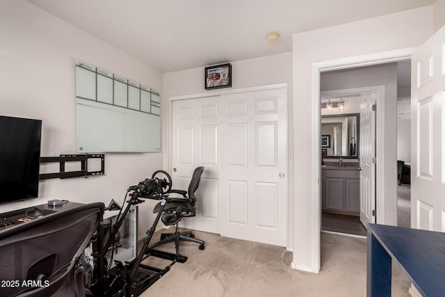 carpeted office space featuring a sink