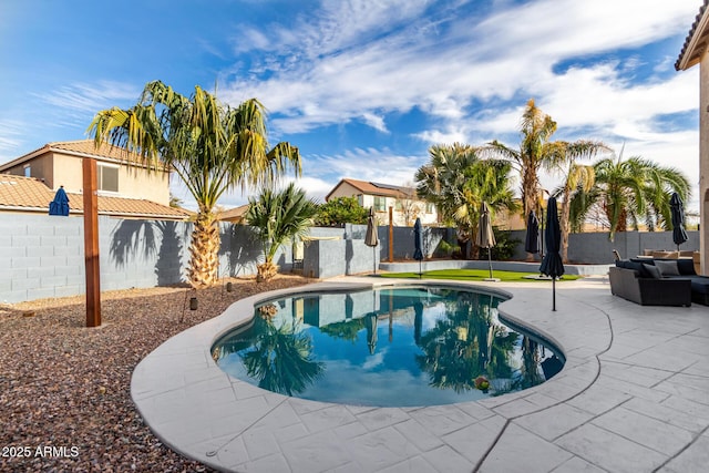 view of pool with a fenced backyard, a patio, and outdoor lounge area