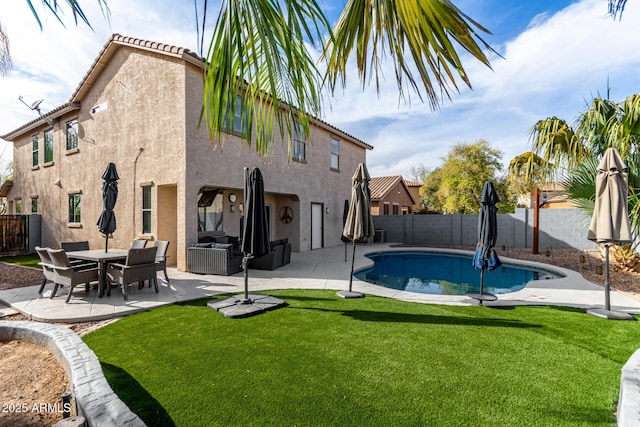 view of swimming pool with a yard, a fenced backyard, a fenced in pool, and a patio