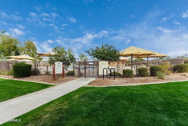 view of home's community featuring a yard, a gate, and fence