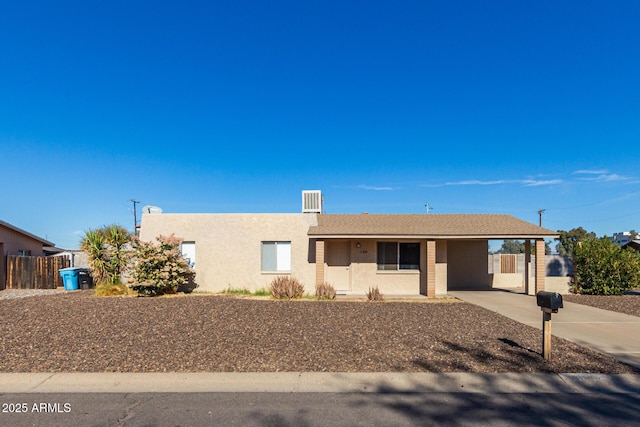 ranch-style home featuring an attached carport and stucco siding