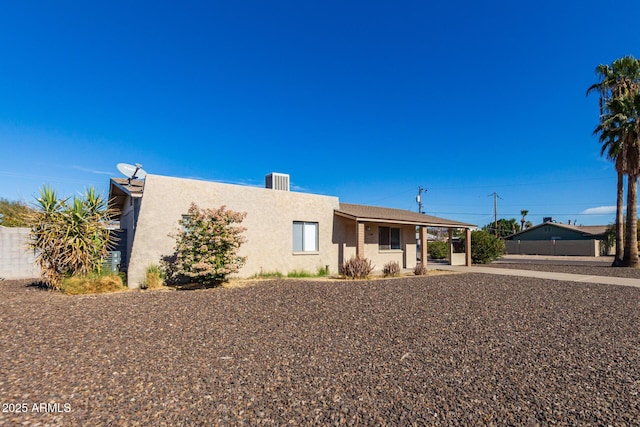 view of front of property with fence and stucco siding