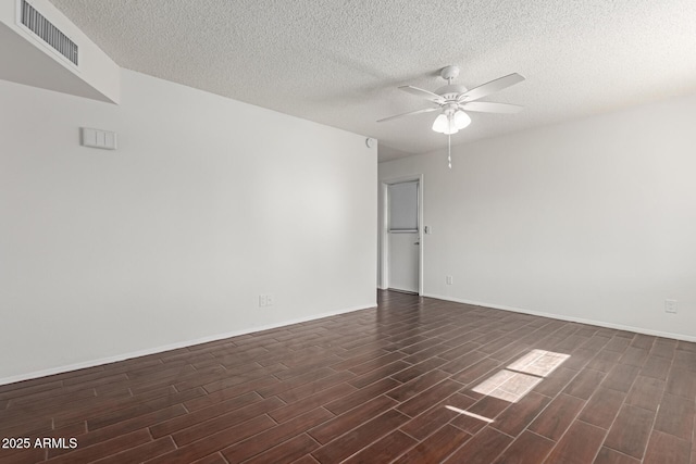 empty room with ceiling fan and a textured ceiling