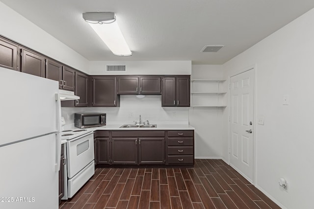 kitchen featuring dark brown cabinets, white appliances, and sink