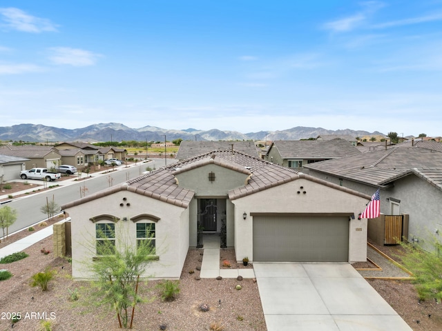 view of front facade featuring a mountain view and a garage