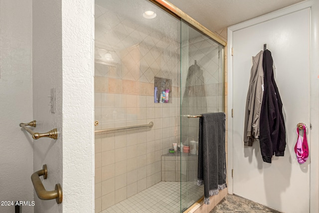 bathroom featuring a shower with door