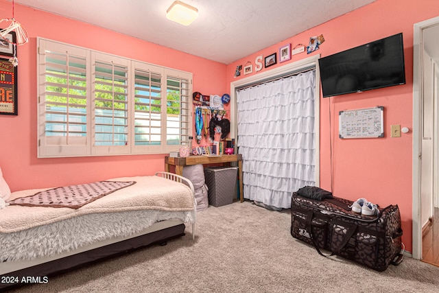 carpeted bedroom featuring a textured ceiling