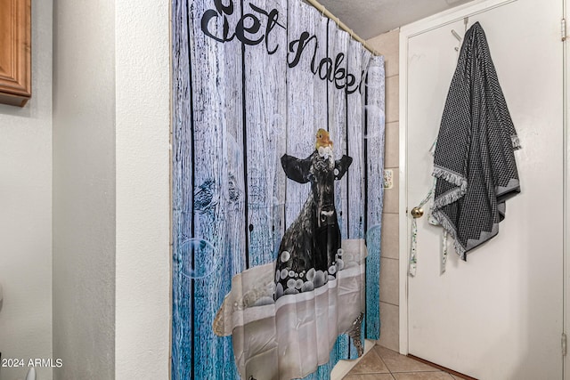 bathroom with tile patterned flooring and curtained shower