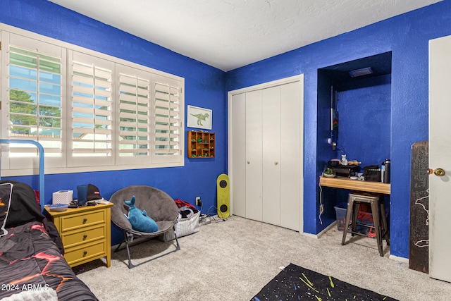 bedroom featuring a closet and light colored carpet