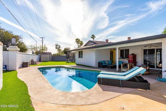 view of pool featuring a storage unit, an outdoor hangout area, a patio area, and a yard