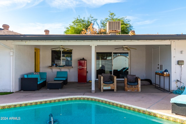 view of swimming pool featuring a patio, ceiling fan, outdoor lounge area, and cooling unit