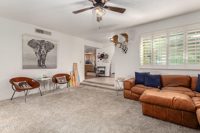 carpeted living room featuring ceiling fan