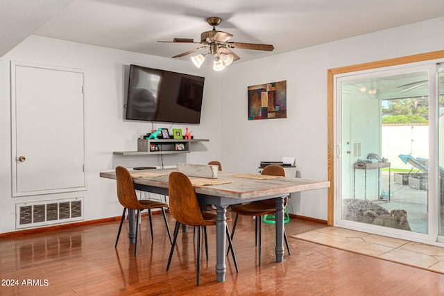 dining area with wood-type flooring and ceiling fan