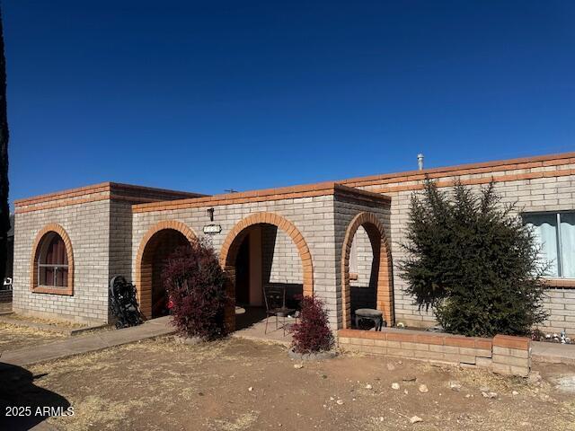 view of front of property featuring brick siding