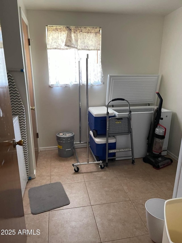 miscellaneous room with baseboards and light tile patterned flooring