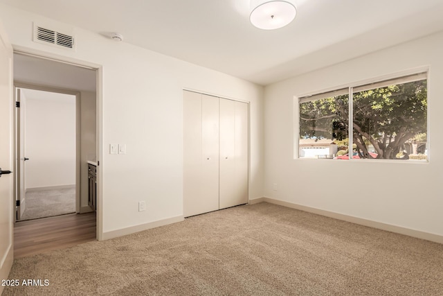 unfurnished bedroom with carpet floors and a closet