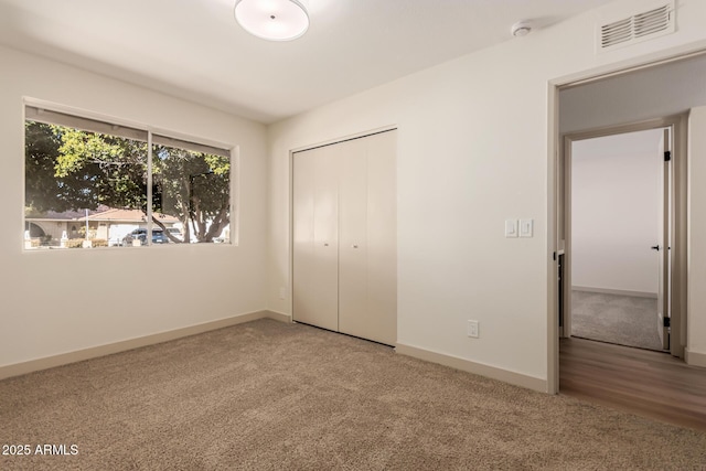 unfurnished bedroom with a closet and carpet