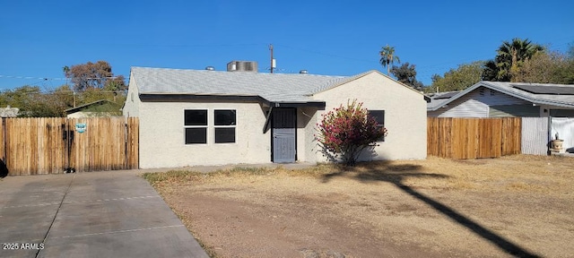 bungalow-style house with fence and stucco siding