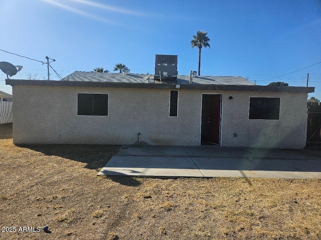 back of house with stucco siding, a patio, and central AC unit