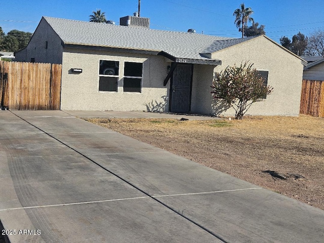 view of front of house featuring fence and stucco siding